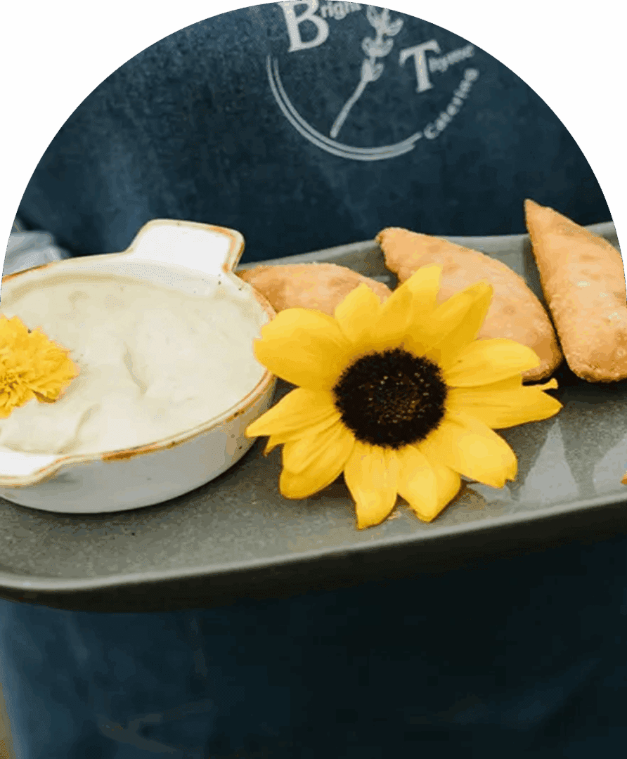 Sunflower and empanadas on a serving tray