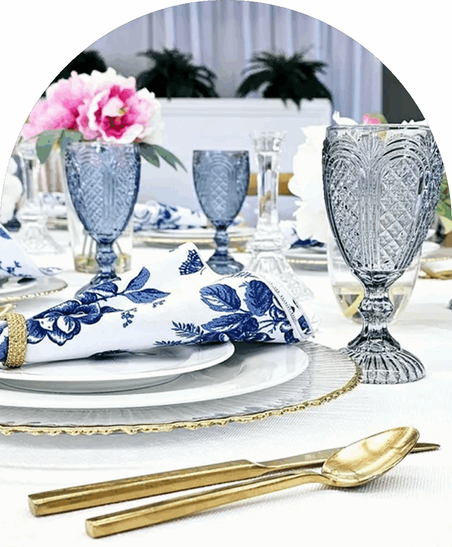 Blue glassware and gold cutlery on table