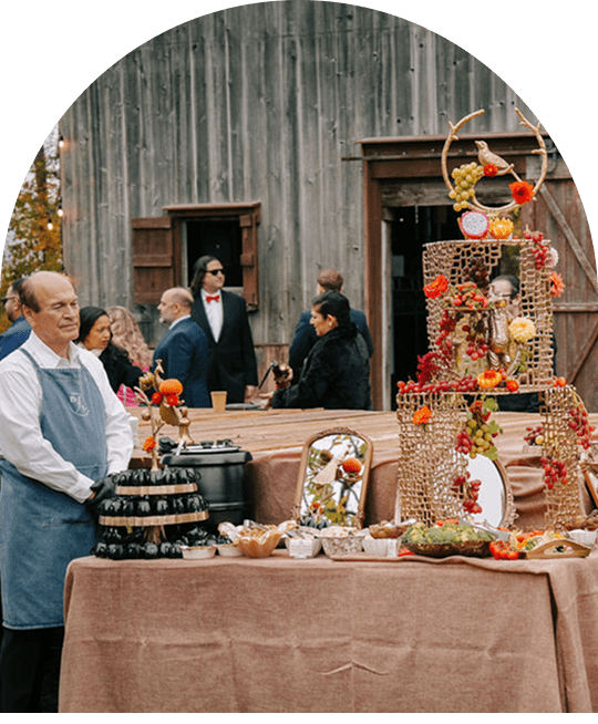A festive outdoor gathering with a decorated dessert table and guests.